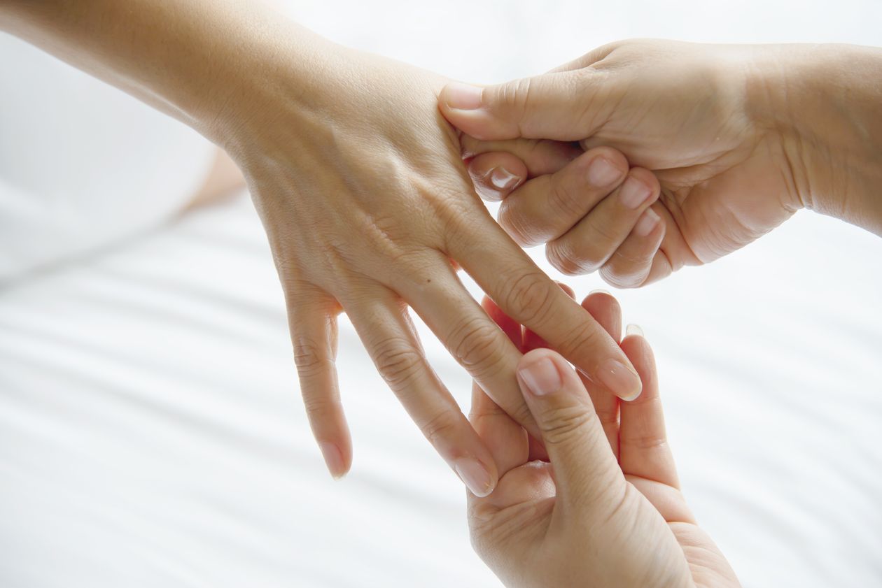 Massage therapist's hands massaging a client