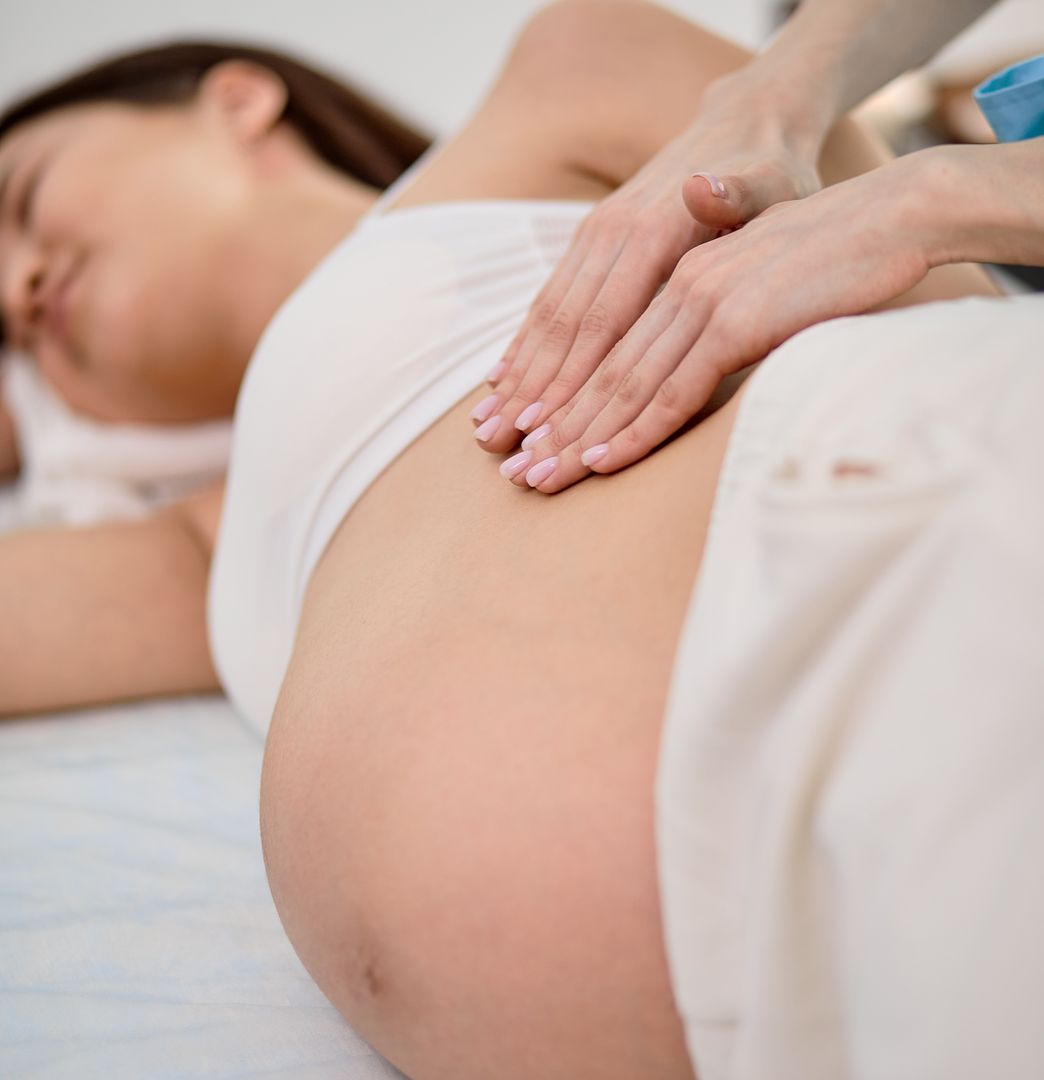 Pregnant client receiving a relaxing prenatal massage